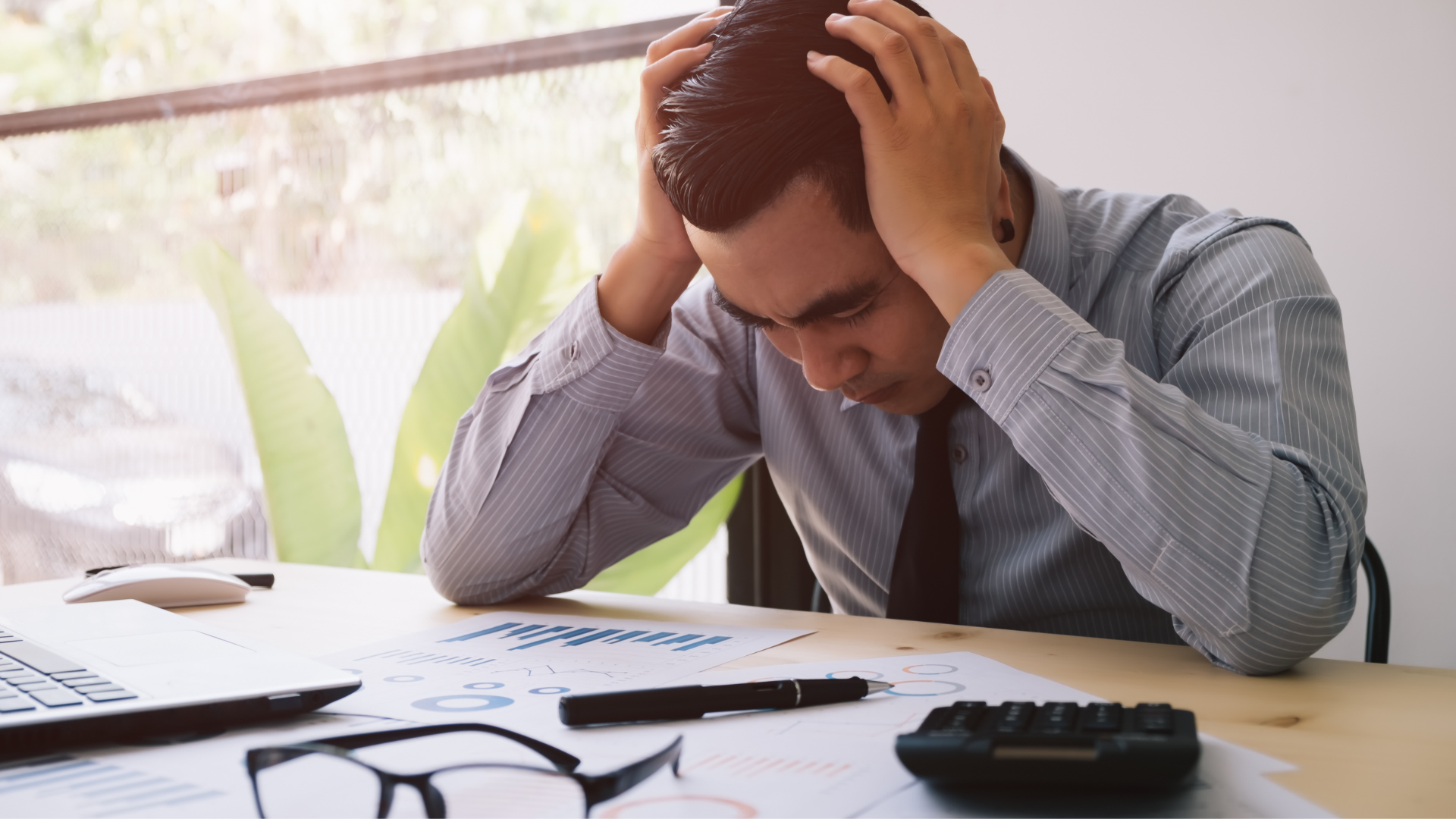 Woman Stressed with Papers and Charts Sitting