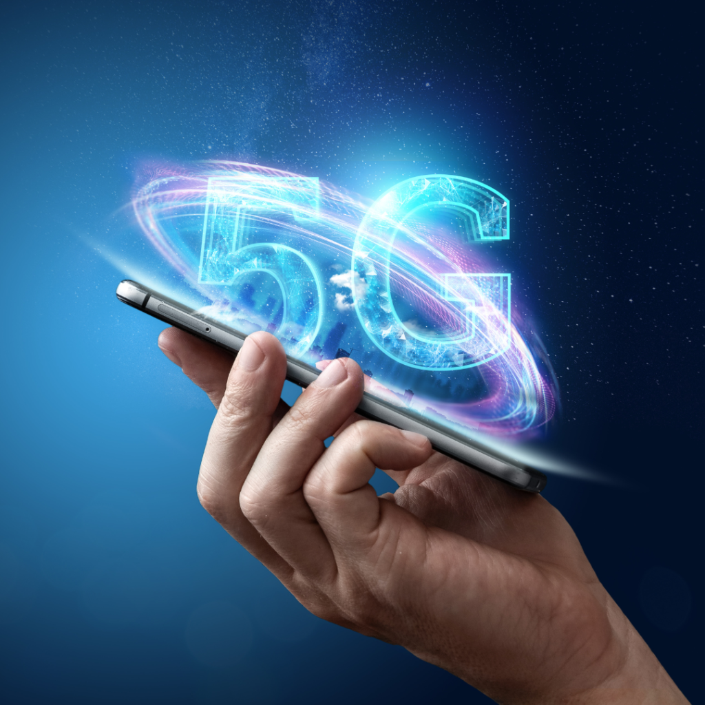 Creative background, male hand holding a phone with a 5G hologram on the background of the city. The concept of 5G network, high-speed mobile Internet, new generation networks. Copy space, Mixed media.