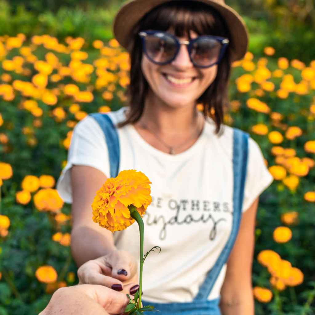 Person Giving Flower To Smiling Woman