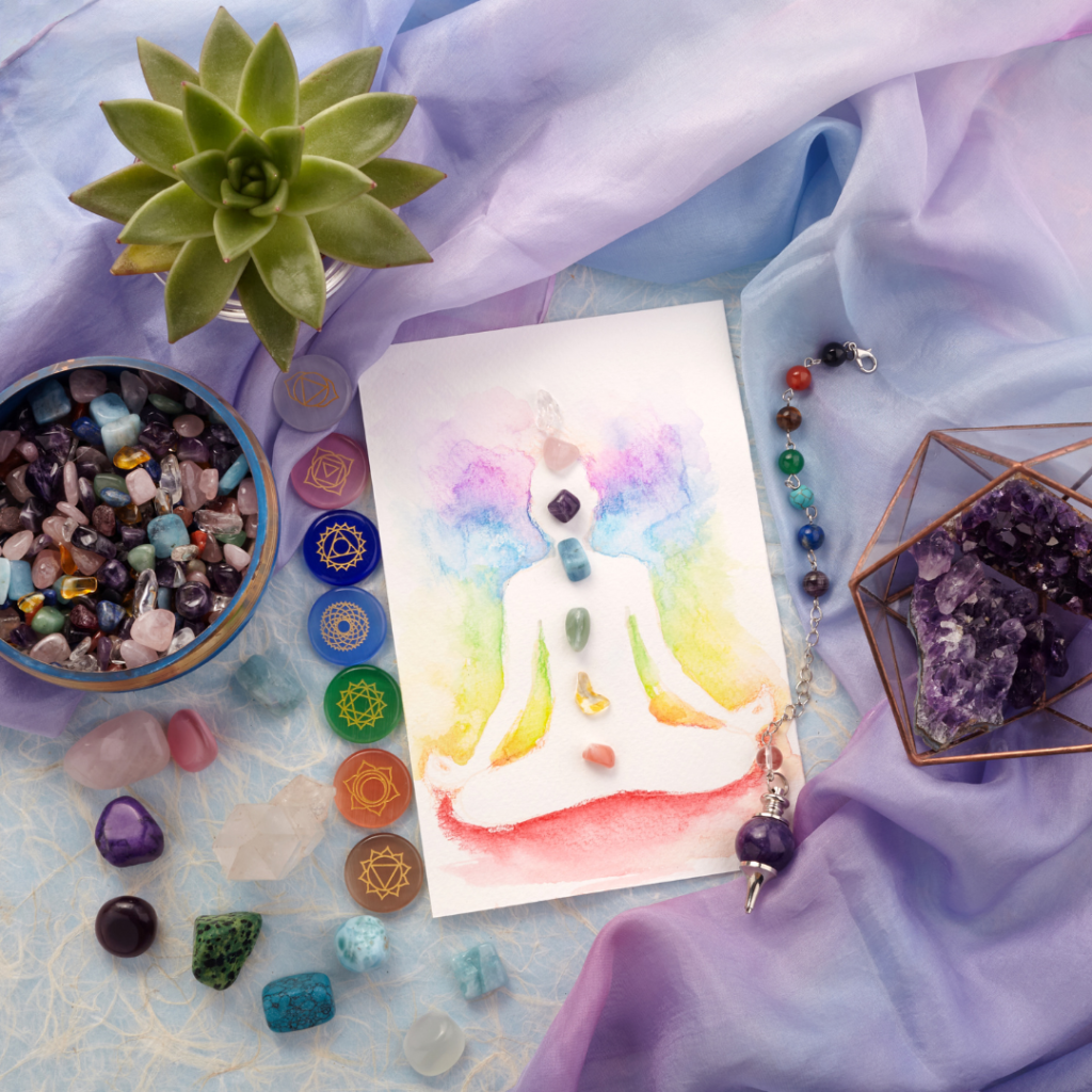 Natural crystals and pendulum on pastel silk background. Reiki background with card.