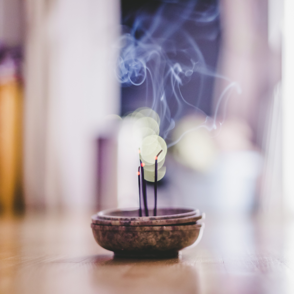 Smoking and smelling joss sticks at home, feng shui; Copy space