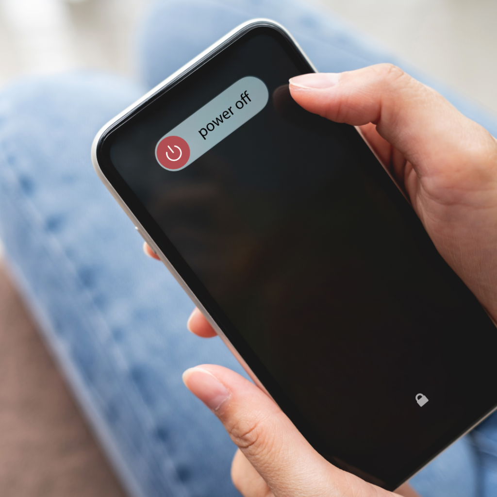 Hands Turning off the Mobile Phone