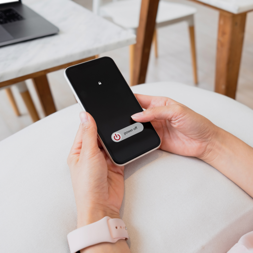 Woman hand using is sliding to turn off the mobile phone