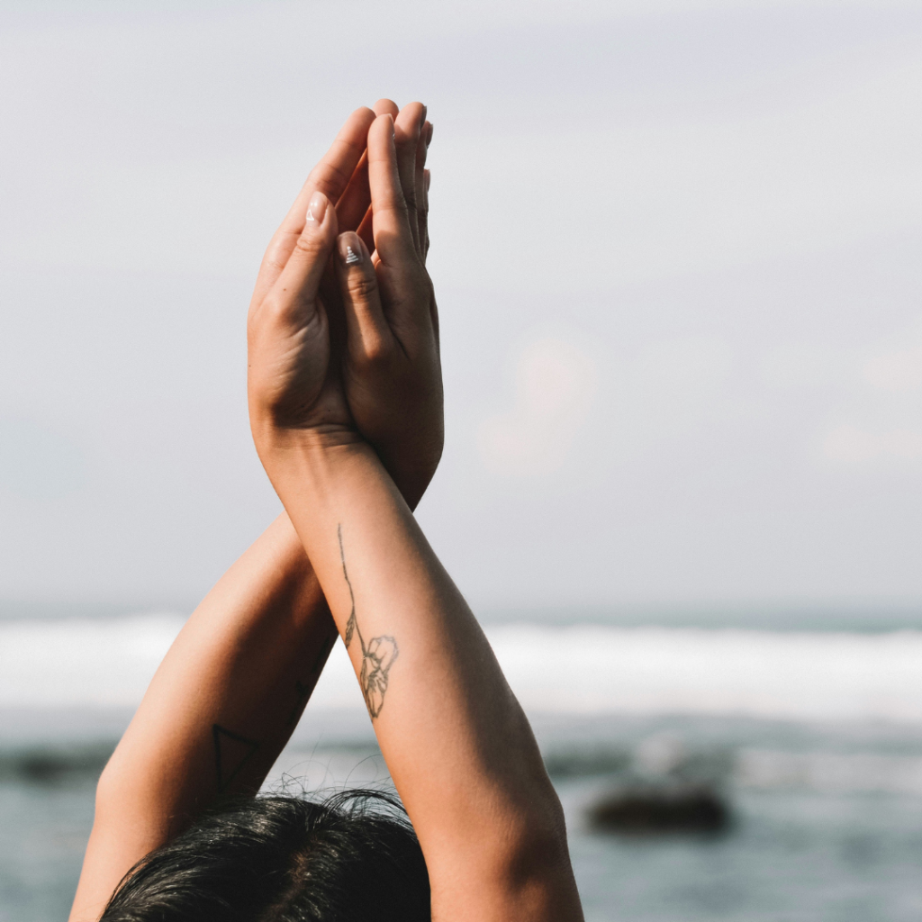 a woman with her hands up in the air